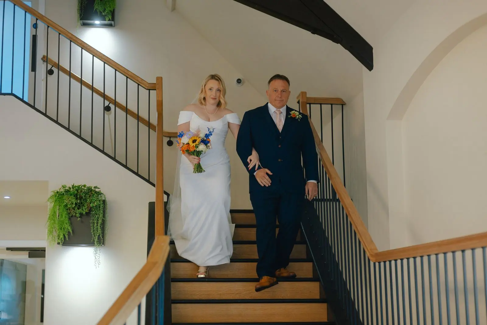 Bride and her father walking down the staircase