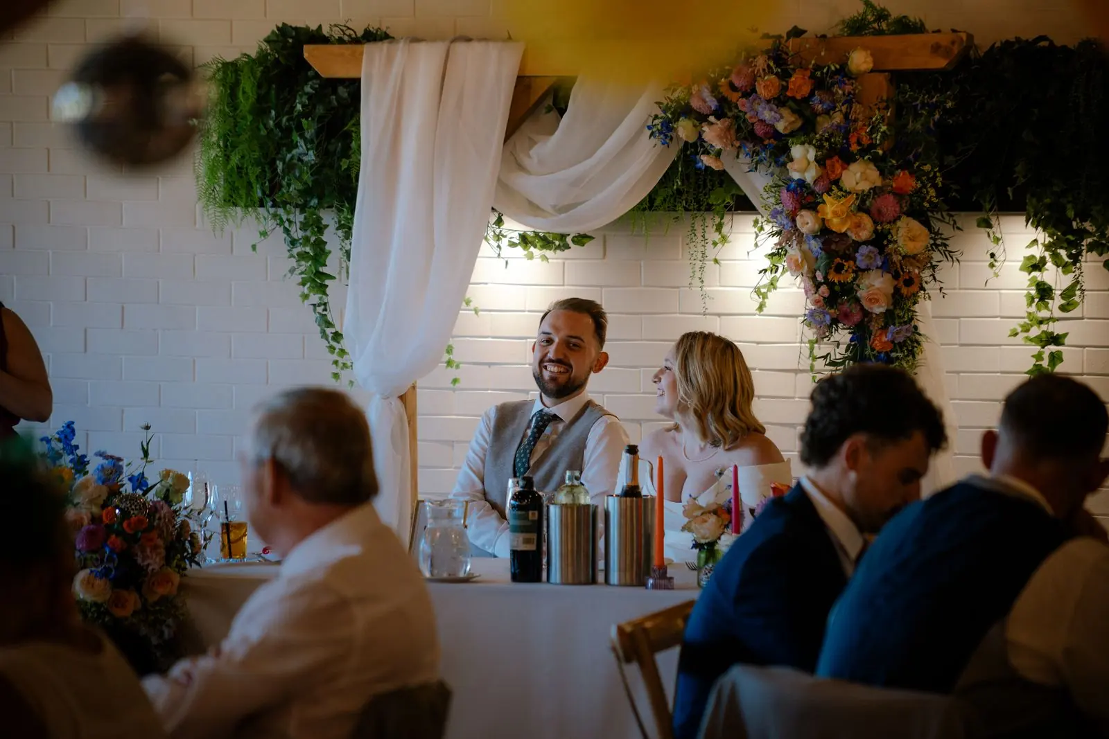 Speeches in front of a floral backdrop