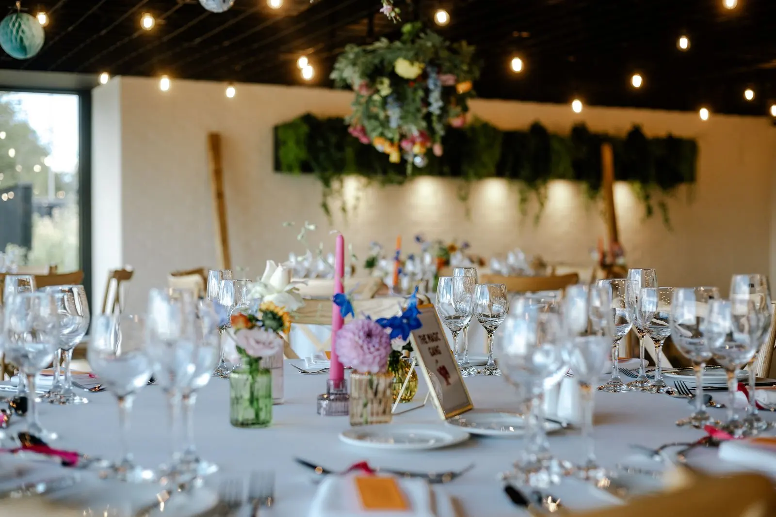 Wedding breakfast tables with colourful flowers