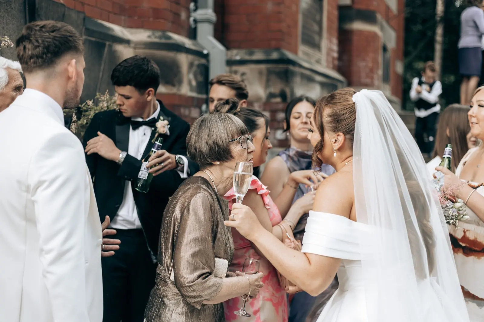 Bride and groom greeting family after the ceremony
