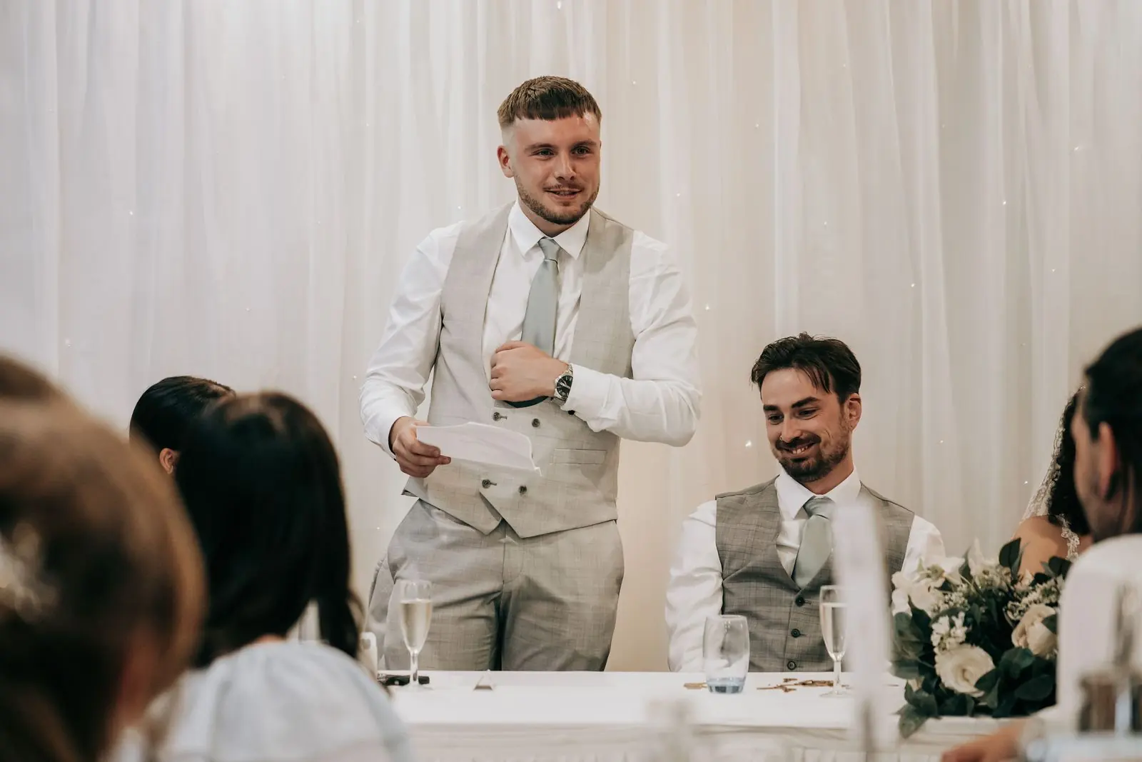 Best man giving his speech at the top table